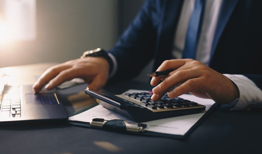 Businessman calculating the financial statement of his business. Accounting and Tax. (1)