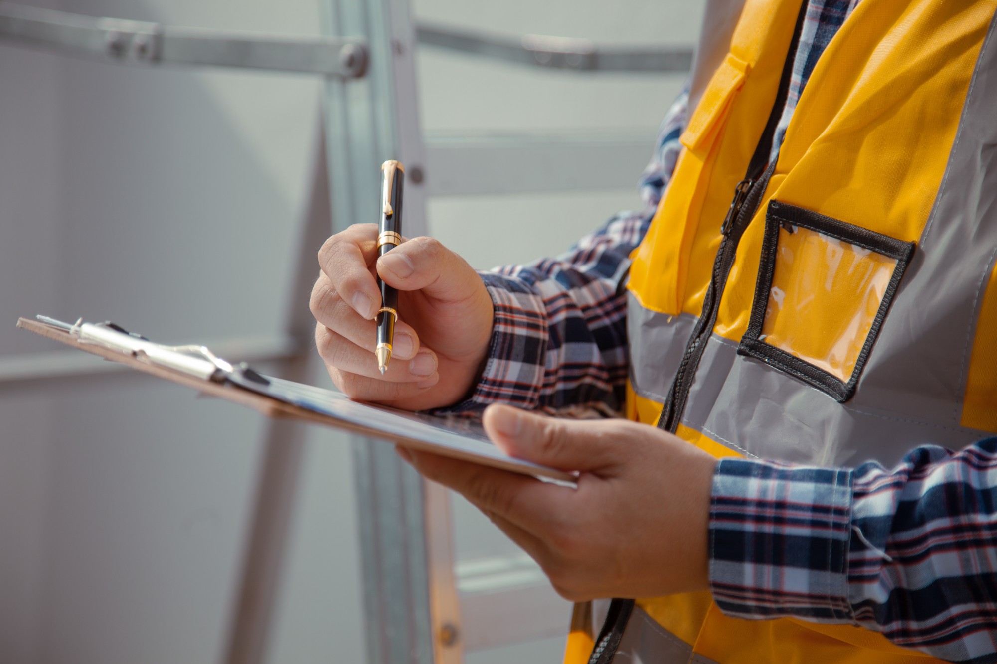 building contractor Check and write down the details of the construction. wearing yellow construction clothes house construction contractor concept (1)