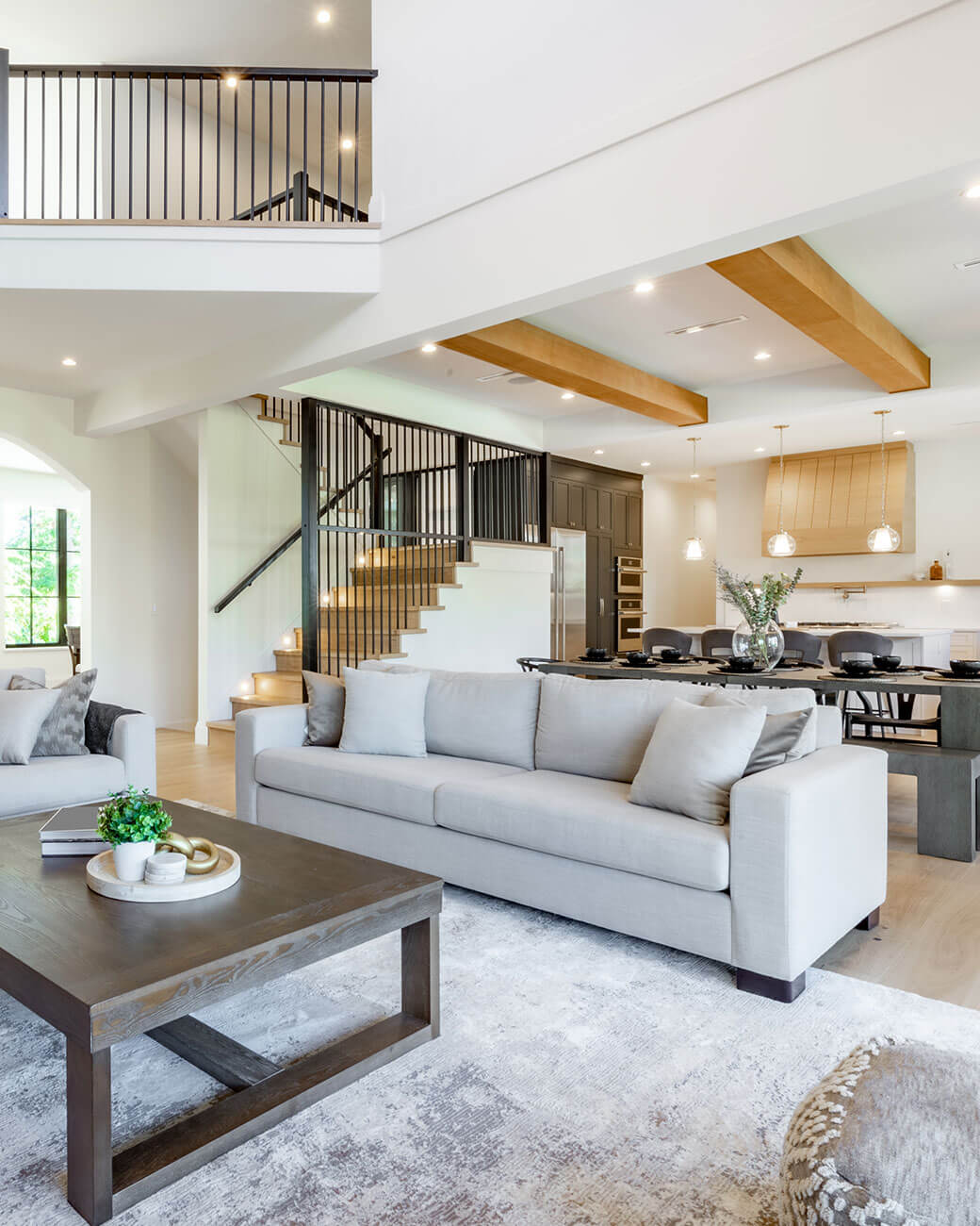Open concept living and dining area with a sectional sofa, coffee table, and dining set.