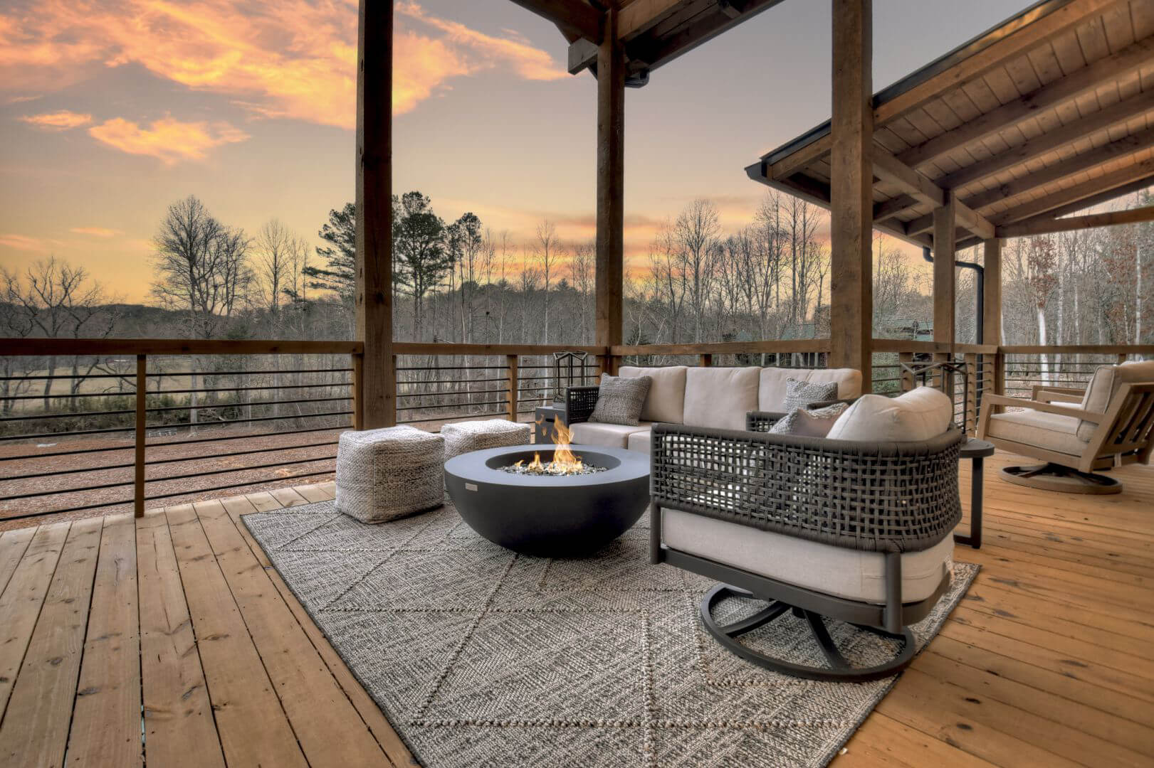 Covered outdoor patio with a gas fire pit and seating.