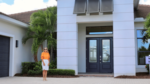 Sarasota Realtor and YouTuber, Lisa McBride in front of a new construction home.