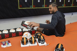 Bru Mccoy signing memorabilia for our Football Giveaway