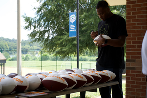 Hendon Hooker Signing the Memorabilia for the Giveaway