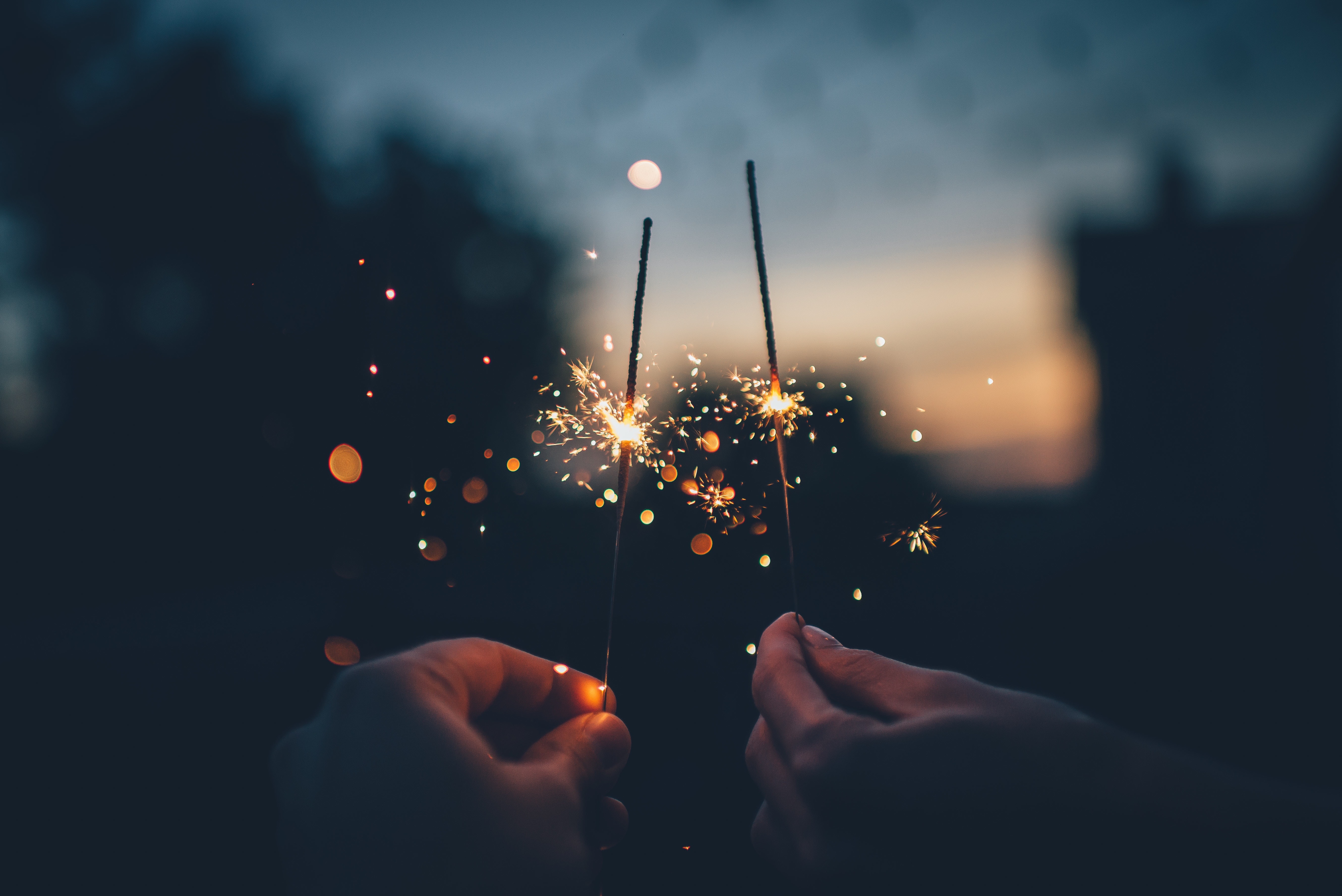 close-up of couple holding sparklers in the evening