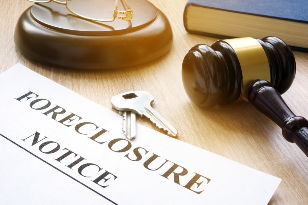 Foreclosure notice with house keys and gavel