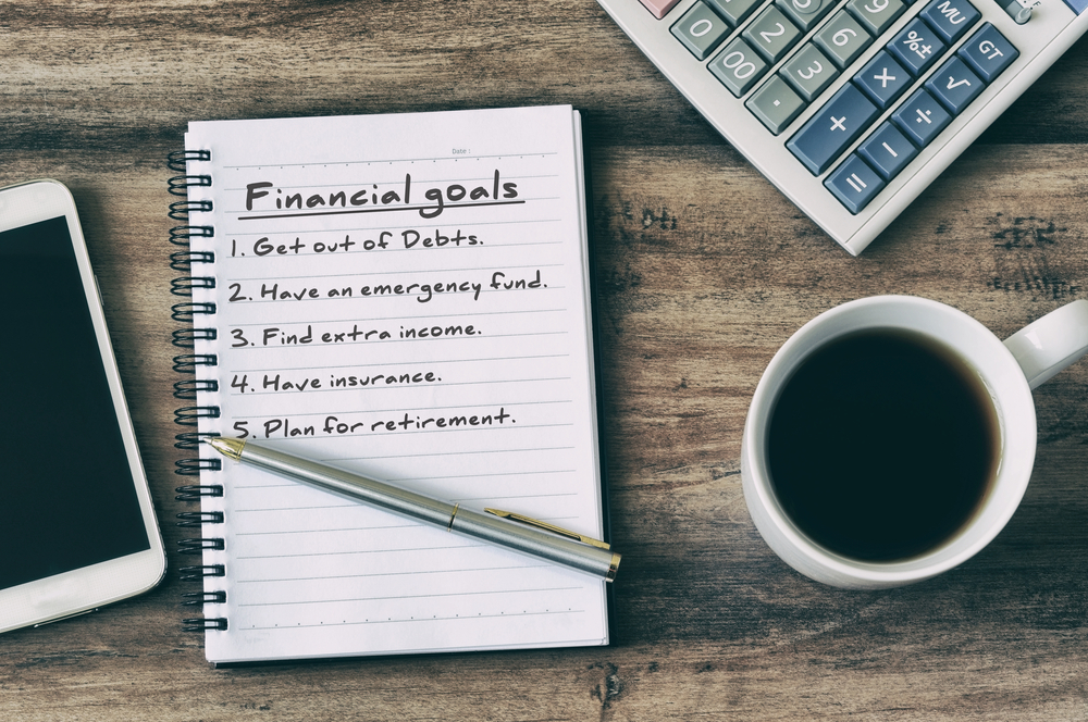 A list of financial goals in a notebook