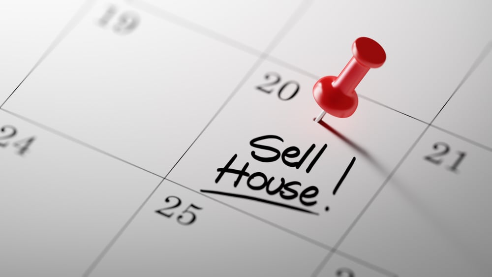 close up of a calendar pinned with "Sell House!"
