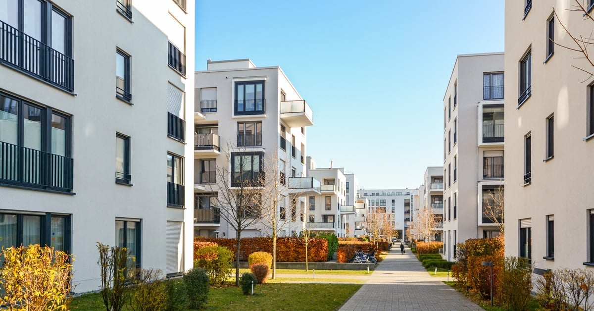 A newly-built real estate development featuring modern apartment buildings and public green spaces.