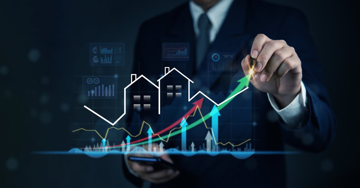 A person in a suit holds a smartphone and draws arrows over glowing house icons and financial graphs.