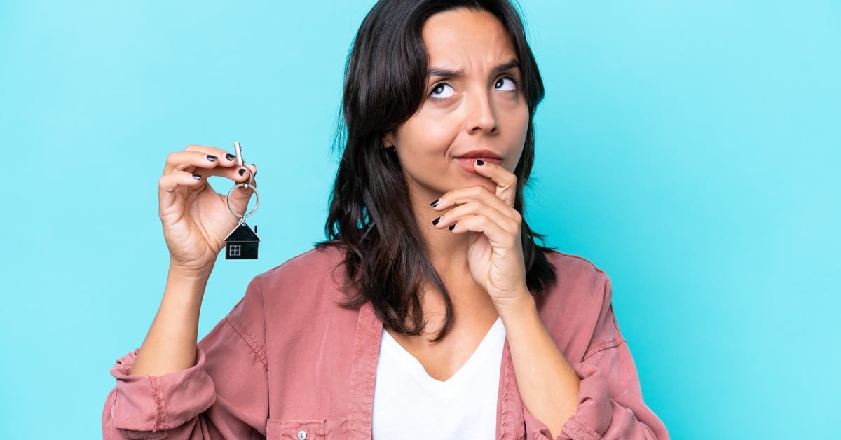 A woman placing her hand on her chin and looking upwards while thinking about something.