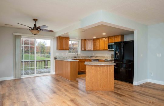 Ceiling Fan, Kitchen Island, Kitchen Counters, Kitchen Cabinets, Refrigerator, Microwave, Sink, recessed lighting