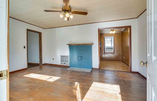 Ceiling Fan, Blue Brick Closed Fireplace, White Painted Paneling Walls, Wood Flooring, Dining room, Window,