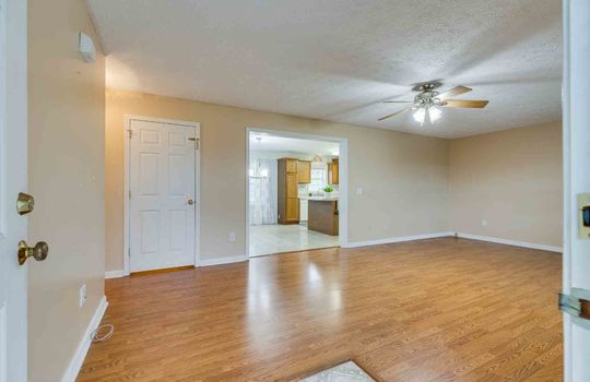 Living room, Windows, Ceiling Fan, Luxury Vinyl Flooring, Entrance to Kitchen, Closet