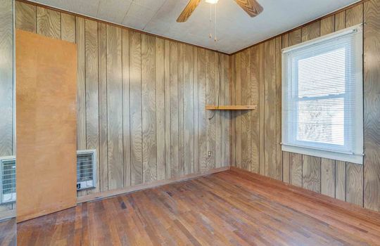 Paneling Walls, Wood Flooring, Ceiling Fan, Radiant Heating, Window, Corner Shelf