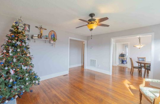 Living Room, Brick Fireplace, Hardwood Flooring, Ceiling Fan, Door to Dining Room