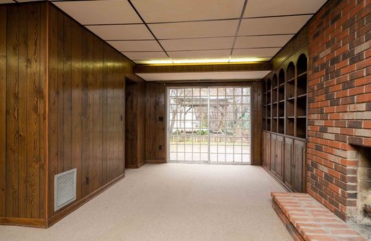 Paneling Wall, Built-in Bookshelves, Brick Fireplace, Wall of Windows