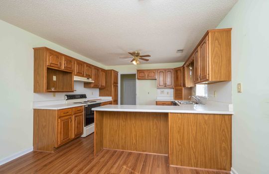 Kitchen, Cabinets, Countertops, Stove, Sink, Ceiling Fan, Window, Doorway, Laminate Flooring