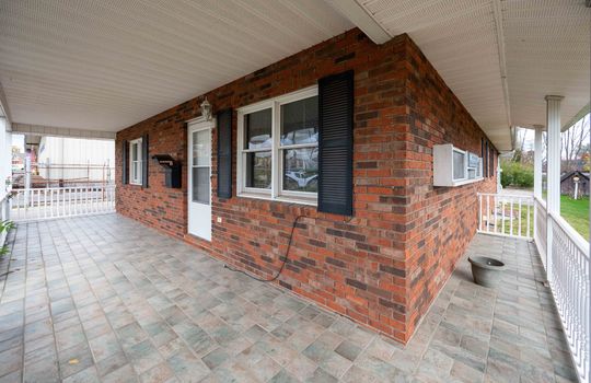 Brick, front dood, windows, mailbox front porch