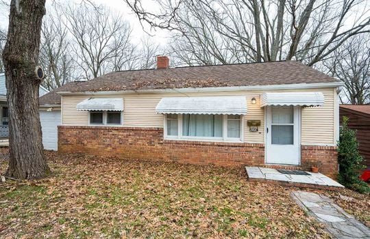 Front of home, brick, vinyl siding, sidewalk, Front door, Awnings, Tree