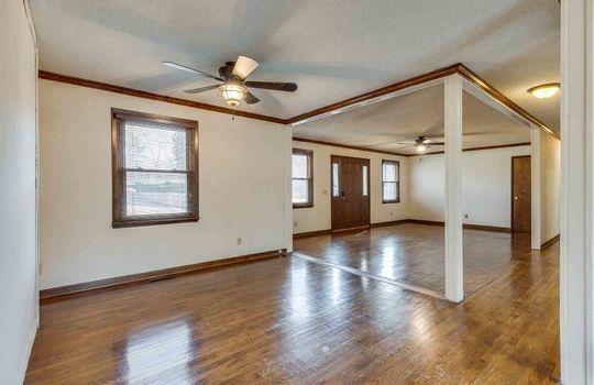 Living room, ceiling fan, hardwood flooring, open floorplan, front entrance