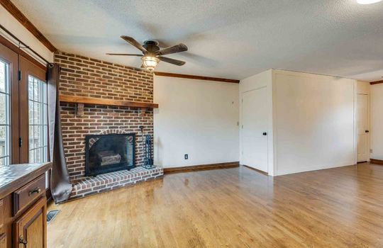 dining room, brick fireplace, hardwood flooring, ceiling fan