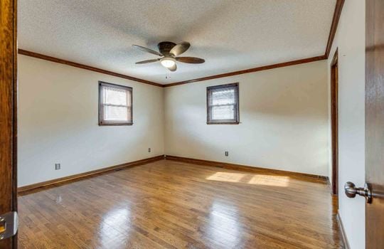 primary bedroom, hardwood flooring, window, ceiling fan