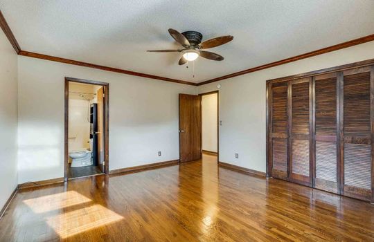primary bedroom, hardwood flooring, ceiling fan, closet, window, ensuite