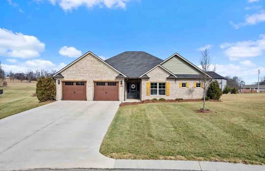 One level brick home, two car garage, concrete driveway, yard, landscaping, front door