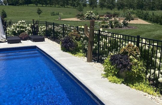 Pool open in summer, green landscaping