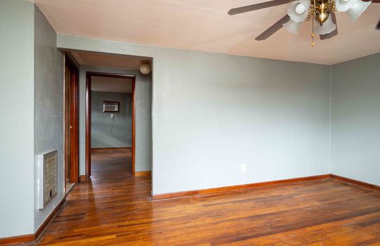 living room, doorway, ceiling fan, hardwood flooring