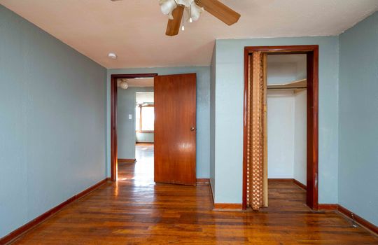 bedroom, doorway, closet, ceiling fan, hardwood flooring
