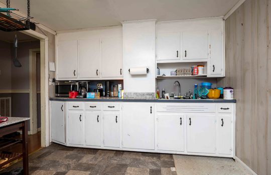 Kitchen, cabinets, counters, sink, vinyl flooring