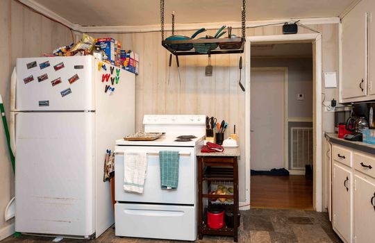 Kitchen, refrigerator, stove, cabinets, vinyl flooring