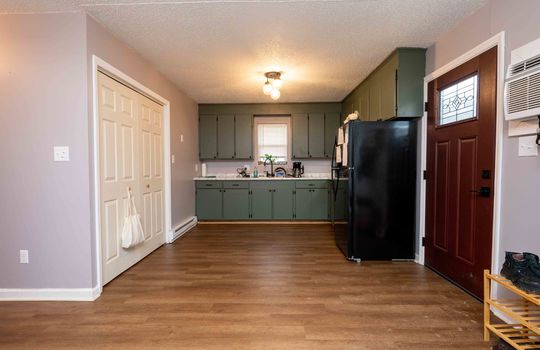134 Monterey - Kitchen, green cabinets, lvt flooring, stove, counters, sink, window
