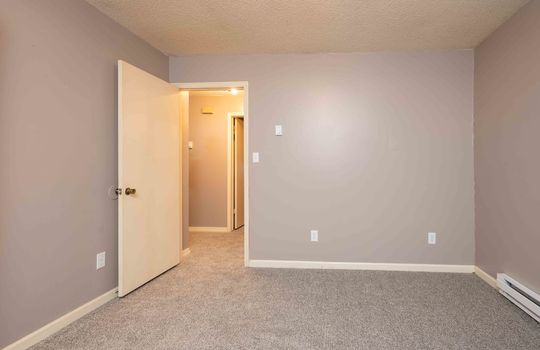 114 Monterey, second bedroom, carpet, doorway, baseboard heating
