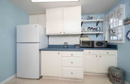 kitchen, counters, cabinets, refrigerator, shelving, vinyl flooring