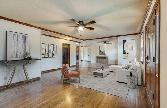living room virtually staged, hardwood flooring, ceiling fan