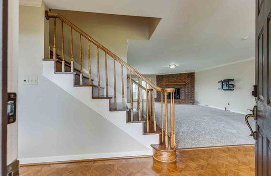 stairs, parquet flooring, carpet, family room, fireplace