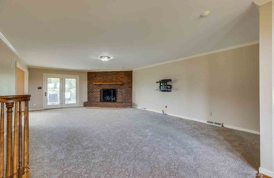 family room, carpet, brick fireplace, french doors