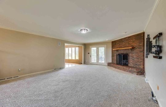 family room, carpet, brick fireplace, french doors