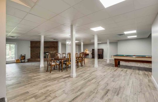 lower level, finished basement, ceiling tiles, brick fireplace