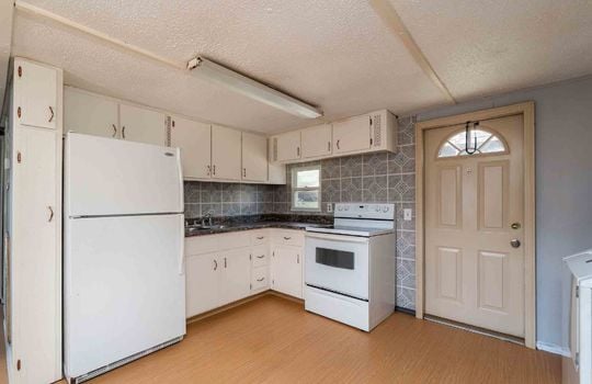 kitchen, window, exterior door, refrigerator, stove, sink, cabinets, counter top