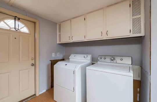 laundry area, exterior door, cabinets