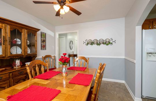 dining room, chair rail, ceiling fan, door to kitchen, refrigerator