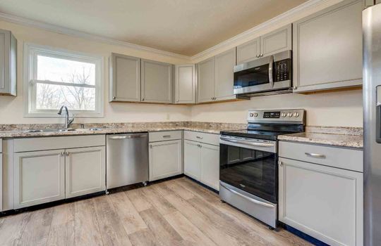 kitchen, shaker cabinets, vinyl flooring, stainless appliances, sink, built-in microwave, stove, refrigerator, dishwasher