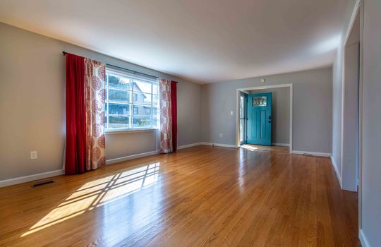 Living room, hardwood flooring, view toward entryway
