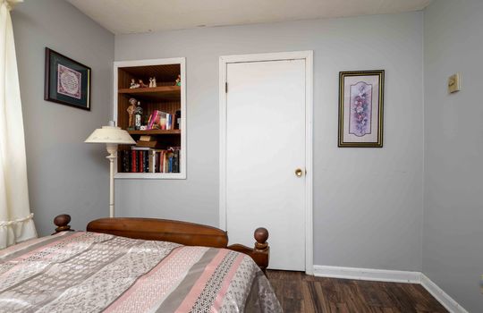 bedroom, built-in shelving, door