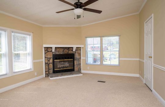 living room, carpet, ceiling fan, entry to kitchen