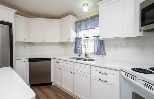 kitchen, cabinets, counters, sink, dishwasher, luxury vinyl flooring