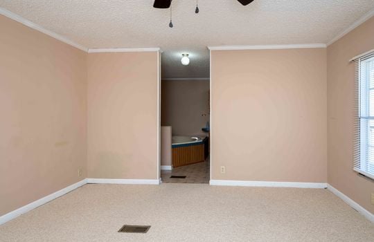 primary bedroom, carpet, door to bathroom, ceiling fan